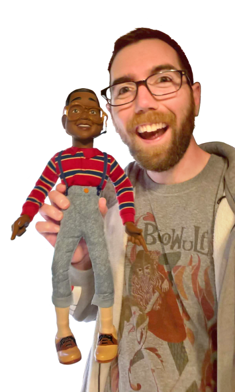 a man holding a Steve Urkel doll